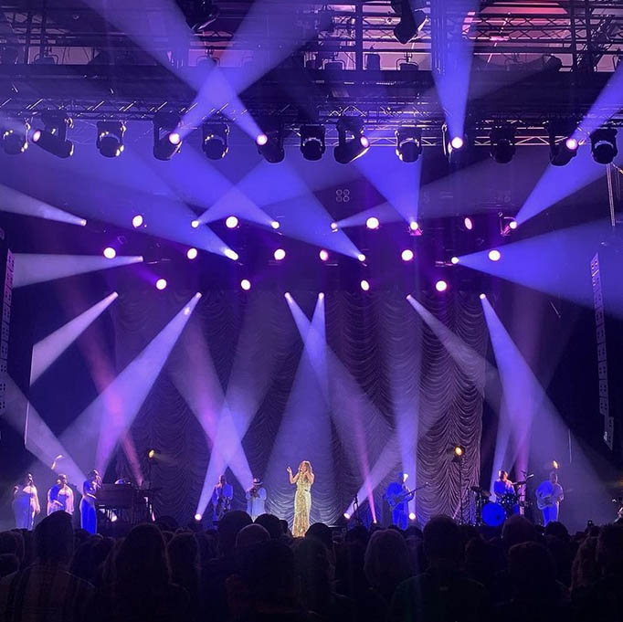 Joss Stone performs on stage with purple beam lighting